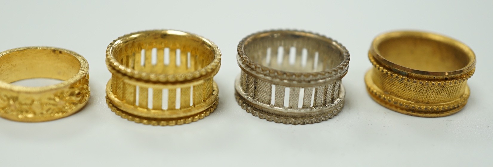 A rare Regency morocco leather mounted white metal cylindrical ring box containing five pinchbeck/base metal sample rings, box length 47mm.